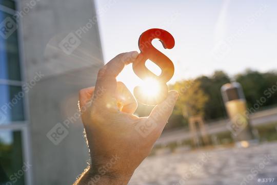 Hand holds paragraph in to the sun  : Stock Photo or Stock Video Download rcfotostock photos, images and assets rcfotostock | RC Photo Stock.: