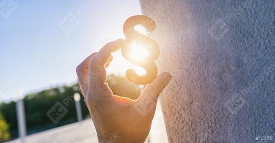 Hand holds paragraph sign in to the sun  : Stock Photo or Stock Video Download rcfotostock photos, images and assets rcfotostock | RC Photo Stock.: