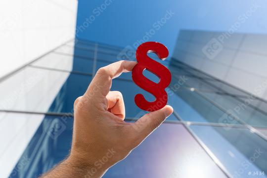 Hand holds paragraph sign to a lawyer office building  : Stock Photo or Stock Video Download rcfotostock photos, images and assets rcfotostock | RC Photo Stock.: