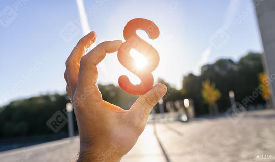 Hand holds paragraph symbol in to the sun as sign for Justice - lady justice or Iustitia / Justitia the Roman goddess of Justice  : Stock Photo or Stock Video Download rcfotostock photos, images and assets rcfotostock | RC Photo Stock.: