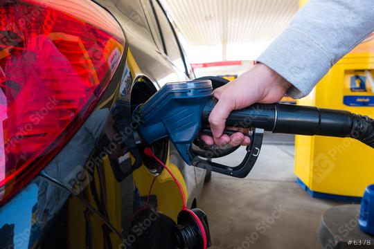 Hand refilling the car with fuel at the refuel station  : Stock Photo or Stock Video Download rcfotostock photos, images and assets rcfotostock | RC Photo Stock.: