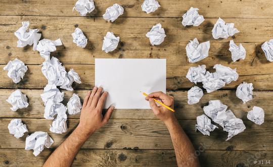Hands holding blank paper sheet to write Mock-up or ideas with a pen surrounded from crumpled paper balls. Brainstorming Concept image  : Stock Photo or Stock Video Download rcfotostock photos, images and assets rcfotostock | RC Photo Stock.: