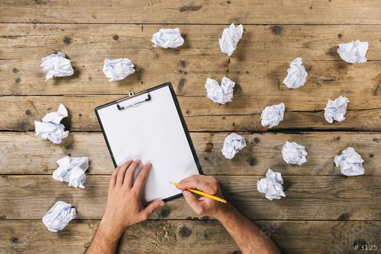 Hands holding clipboard and write Mock-up or ideas with crumpled paper balls. Brainstorming Concept image  : Stock Photo or Stock Video Download rcfotostock photos, images and assets rcfotostock | RC Photo Stock.: