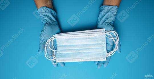 Hands in gloves showing many medical face mask on blue background. Preventive measures to protect against Covid-19 Corona virus infection.  : Stock Photo or Stock Video Download rcfotostock photos, images and assets rcfotostock | RC Photo Stock.: