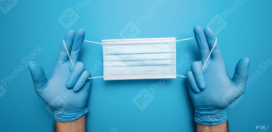Hands in gloves showing medical face mask on blue background. Preventive measures to protect against Covid-19 Corona virus infection.  : Stock Photo or Stock Video Download rcfotostock photos, images and assets rcfotostock | RC Photo Stock.: