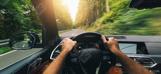 Hands of car driver on steering wheel, fast driving car at spring day on a country road, having fun driving the empty highway on tour journey - POV first person view shot  : Stock Photo or Stock Video Download rcfotostock photos, images and assets rcfotostock | RC Photo Stock.: