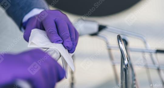 Hands with gloves using cloth with alcohol antiseptic, disinfecting spray, cleaning on shopping cart, trolley handle, protection during Coronavirus pandemic, Covid-19, wipe surface with disinfectant  : Stock Photo or Stock Video Download rcfotostock photos, images and assets rcfotostock | RC Photo Stock.:
