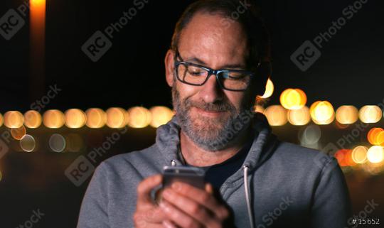Handsome mature man speaking on smart phone at autumn sunset in city  : Stock Photo or Stock Video Download rcfotostock photos, images and assets rcfotostock | RC Photo Stock.: