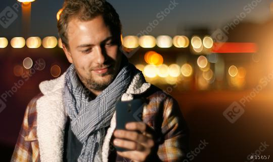 Handsome young man sms texting using app on smart phone at autum /summer sunset in city  : Stock Photo or Stock Video Download rcfotostock photos, images and assets rcfotostock | RC Photo Stock.: