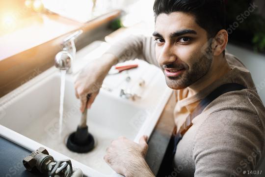 Handyman at work. Repairing kitchen sink by plunger. man trying to fix kitchen sink.  : Stock Photo or Stock Video Download rcfotostock photos, images and assets rcfotostock | RC Photo Stock.:
