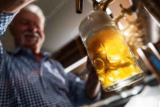 happy bartender in tracht pouring draft beer at german Oktoberfest or Biergarten  : Stock Photo or Stock Video Download rcfotostock photos, images and assets rcfotostock | RC Photo Stock.: