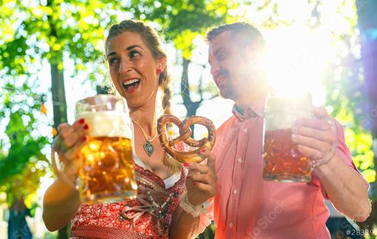 Happy Couple in Beer garden or oktoberfest making party and enjoying a glass of beer and the sun  : Stock Photo or Stock Video Download rcfotostock photos, images and assets rcfotostock | RC Photo Stock.: