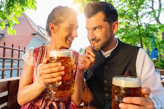 Happy Couple sitting in Beer garden and feeding with Pretzel Sticks enjoy the beer and the sun  : Stock Photo or Stock Video Download rcfotostock photos, images and assets rcfotostock | RC Photo Stock.: