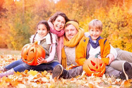 Happy family of four sitting in a park surrounded by autumn leaves, holding carved pumpkins, enjoying a festive fall day with warm scarves and jackets, and vibrant fall foliage in the background
  : Stock Photo or Stock Video Download rcfotostock photos, images and assets rcfotostock | RC Photo Stock.: