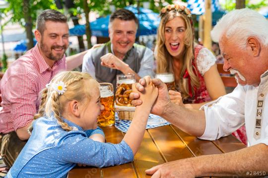 Happy family practicing the high art of arm wrestling in a beer garden ir oktoberste  : Stock Photo or Stock Video Download rcfotostock photos, images and assets rcfotostock | RC Photo Stock.: