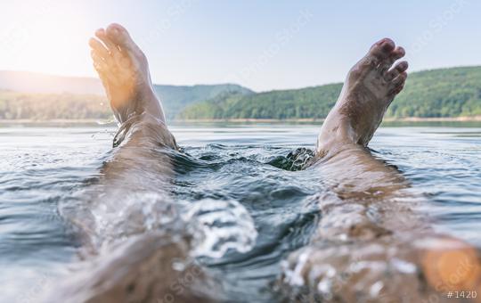 Happy man having fun and splashing water with his feet on a lake  : Stock Photo or Stock Video Download rcfotostock photos, images and assets rcfotostock | RC Photo Stock.:
