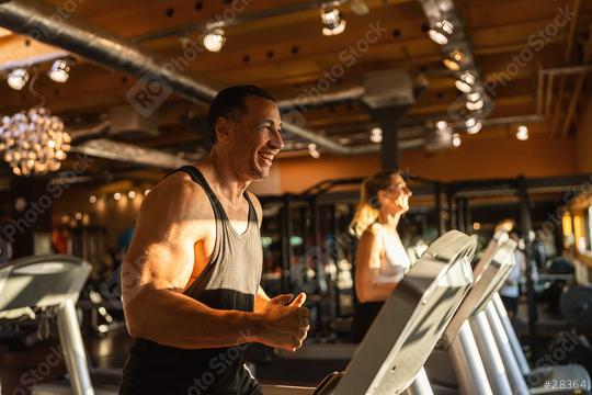 Happy men and woman in the gym running on treadmill  : Stock Photo or Stock Video Download rcfotostock photos, images and assets rcfotostock | RC Photo Stock.: