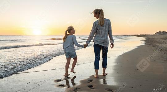 Happy mother and daughter walking together on the beach in holiday. Family holding hands enjoying the sunset on the beach. Happy family travel and vacations concept image.   : Stock Photo or Stock Video Download rcfotostock photos, images and assets rcfotostock | RC Photo Stock.: