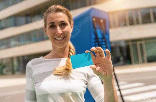 Happy woman holding Nfc or Rfid card on a  Hypercharger or Super  : Stock Photo or Stock Video Download rcfotostock photos, images and assets rcfotostock | RC Photo Stock.: