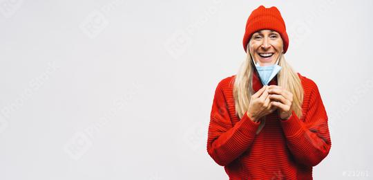 Happy Woman takes off knN95 FFP2 an anti virus protection face mask. Woman removing protective face mask to take a breath and smiles aftter during COVID-19 corona pandemic. with copy space banner  : Stock Photo or Stock Video Download rcfotostock photos, images and assets rcfotostock | RC Photo Stock.: