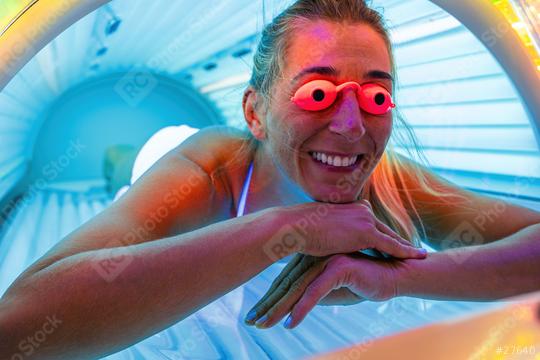 happy young woman tanning in solarium with glasses  : Stock Photo or Stock Video Download rcfotostock photos, images and assets rcfotostock | RC Photo Stock.: