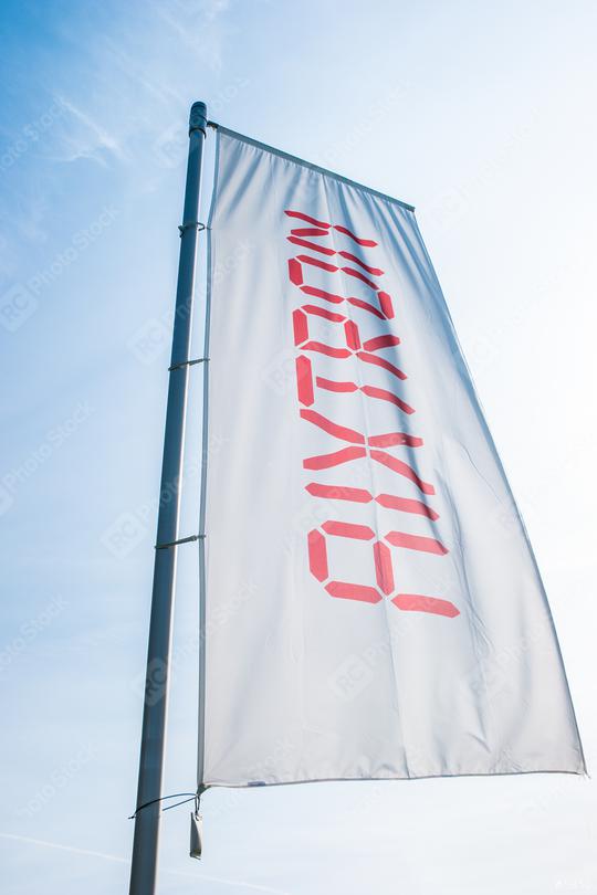HERZOGENRATH, GERMANY MARCH, 2017: Aixtron flag against blue sky. The engineering company.produces equipment for the production of compound semiconductors and other multicomponent materials.  : Stock Photo or Stock Video Download rcfotostock photos, images and assets rcfotostock | RC Photo Stock.: