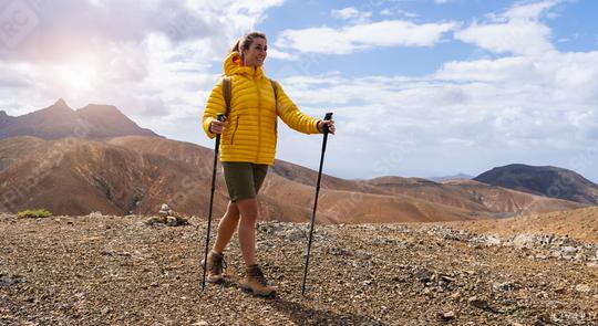 Hiker in yellow jacket with trekking poles on a mountain trail under a cloudy sky  : Stock Photo or Stock Video Download rcfotostock photos, images and assets rcfotostock | RC Photo Stock.: