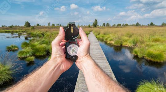 Hiker man searching direction with a compass in the hautes fagnes. Point of view shot  : Stock Photo or Stock Video Download rcfotostock photos, images and assets rcfotostock | RC Photo Stock.: