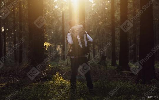 Hiker standing in the forest and watching sunset over trees  : Stock Photo or Stock Video Download rcfotostock photos, images and assets rcfotostock | RC Photo Stock.: