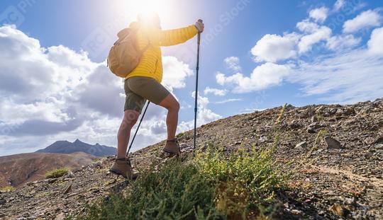 Hiker with backpack and trekking pole ascending a mountain trail under a cloudy sky  : Stock Photo or Stock Video Download rcfotostock photos, images and assets rcfotostock | RC Photo Stock.: