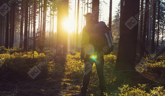 Hiker with backpack relaxe in the woods and enjoys the view of the sunset  : Stock Photo or Stock Video Download rcfotostock photos, images and assets rcfotostock | RC Photo Stock.:
