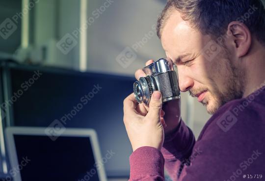 Hipster young man holding a vintage camera and taking a picture  : Stock Photo or Stock Video Download rcfotostock photos, images and assets rcfotostock | RC Photo Stock.: