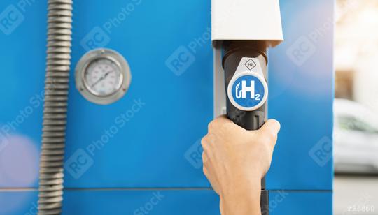 hold a fuel dispenser with hydrogen logo on gas station. h2 combustion engine for emission free eco friendly transport concept image  : Stock Photo or Stock Video Download rcfotostock photos, images and assets rcfotostock | RC Photo Stock.: