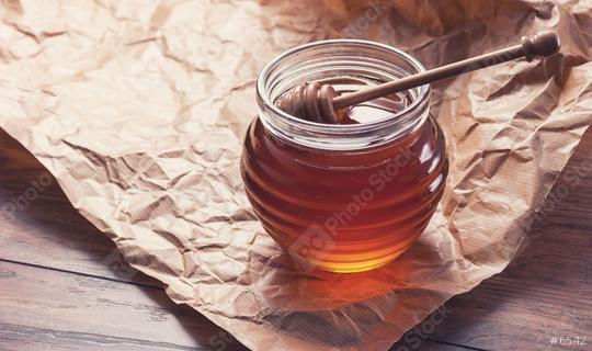 Honey in a pot or jar on paper with Honey dipper  : Stock Photo or Stock Video Download rcfotostock photos, images and assets rcfotostock | RC Photo Stock.:
