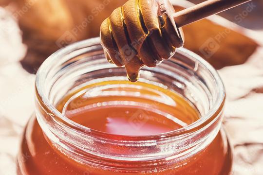 Honey runs from a dipper in to a glass of jar  : Stock Photo or Stock Video Download rcfotostock photos, images and assets rcfotostock | RC Photo Stock.: