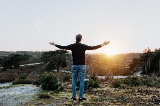 Hopeful thoughtful woman with open arms holds out her hands in the air. Person in nature is relaxed, peaceful, determined, full of hope and enjoys life.  : Stock Photo or Stock Video Download rcfotostock photos, images and assets rcfotostock | RC-Photo-Stock.: