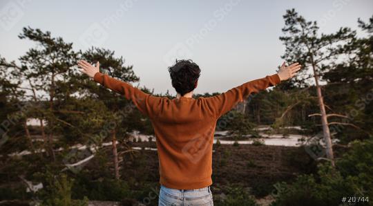 Hopeful, thoughtful young man with arms wide open. Joyfully stretches his hands up in the air. Man is positive and he enjoys life.   : Stock Photo or Stock Video Download rcfotostock photos, images and assets rcfotostock | RC Photo Stock.: