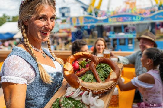 In oktoberfest in Bavaria, Germany - beer and snacks are served by a smiling waitress in traditional Bavarian dress or dirndl  : Stock Photo or Stock Video Download rcfotostock photos, images and assets rcfotostock | RC Photo Stock.: