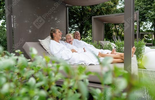 joyful family of three, mother, father, and daughter, laughing together while relaxing in a luxury spa cabana outdoors  : Stock Photo or Stock Video Download rcfotostock photos, images and assets rcfotostock | RC Photo Stock.: