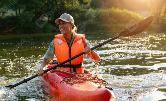 Joyful woman kayaking on a river, paddling with splashes in evening sunlight. Kayak Water Sports concept image  : Stock Photo or Stock Video Download rcfotostock photos, images and assets rcfotostock | RC Photo Stock.: