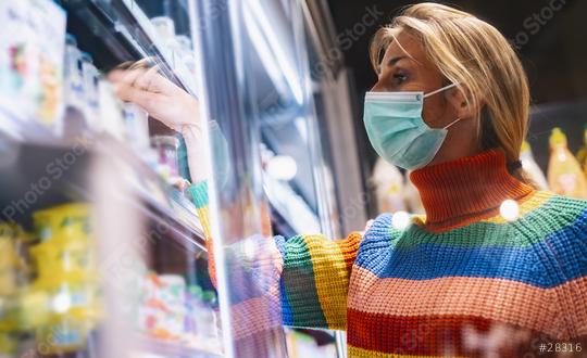 lesbian gay woman wearing rainbow sweater with face mask and buying groceries in freezer section at the supermarket during Coronavirus pandemic   : Stock Photo or Stock Video Download rcfotostock photos, images and assets rcfotostock | RC Photo Stock.: