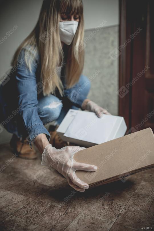 letter carrier drops letters and packages in the hallway without contact in times of quarantine with gloves and ffp2 face mask  : Stock Photo or Stock Video Download rcfotostock photos, images and assets rcfotostock | RC Photo Stock.: