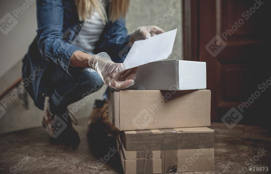 letter carrier drops letters and packages in the hallway without contact in times of quarantine with gloves and ffp2 face mask  : Stock Photo or Stock Video Download rcfotostock photos, images and assets rcfotostock | RC Photo Stock.: