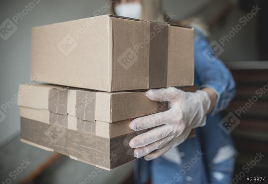 letter carrier drops letters and packages in the hallway without contact in times of quarantine with gloves and ffp2 face mask  : Stock Photo or Stock Video Download rcfotostock photos, images and assets rcfotostock | RC Photo Stock.: