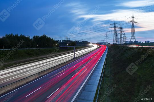 Light trails on a highway freeway at sunset with power Pylons in the background  : Stock Photo or Stock Video Download rcfotostock photos, images and assets rcfotostock | RC Photo Stock.: