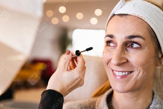 make up assistant applying make up to eyelashes of a happy model for a photoshoot on location.  : Stock Photo or Stock Video Download rcfotostock photos, images and assets rcfotostock | RC Photo Stock.: