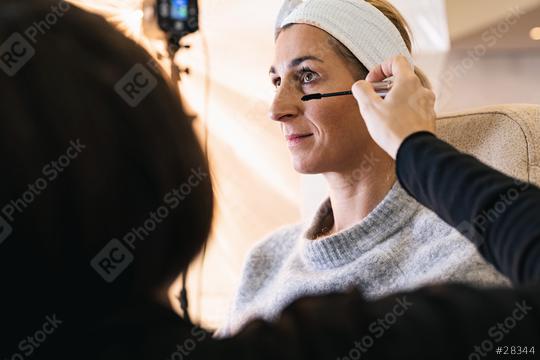 make up assistant applying make up to eyelashes of a model for a photoshoot on location.  : Stock Photo or Stock Video Download rcfotostock photos, images and assets rcfotostock | RC Photo Stock.: