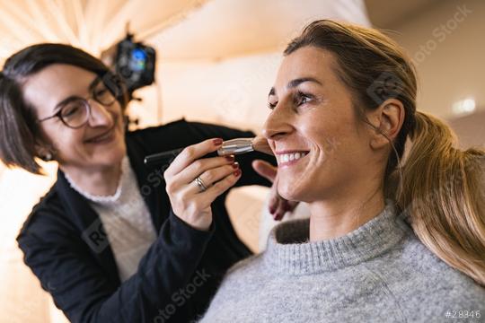 make up assistant applying make up with beauty brush to the face of a happy model for a photoshoot oder movie on location.  : Stock Photo or Stock Video Download rcfotostock photos, images and assets rcfotostock | RC Photo Stock.: