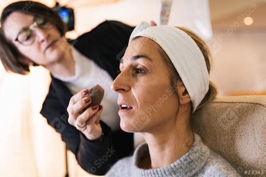 make up assistant applying make up with makeup sponge to face of a model for a photoshoot on location.  : Stock Photo or Stock Video Download rcfotostock photos, images and assets rcfotostock | RC Photo Stock.: