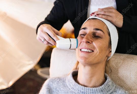 make up assistant cleaning the face of a model with a professional care device for a photoshoot or movie on location.  : Stock Photo or Stock Video Download rcfotostock photos, images and assets rcfotostock | RC Photo Stock.: